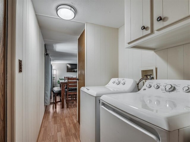 332 Royal Ln, Canadian, OK 74425 - washroom with light wood-style flooring, washer and dryer, and cabinet space