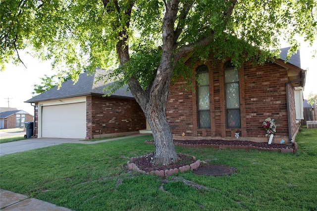 11332 Cimarron Dr, Oklahoma City, OK 73162 - view of front of home featuring a front yard, brick siding, concrete driveway, and an attached garage