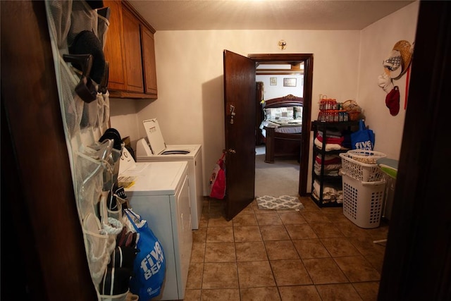 11332 Cimarron Dr, Oklahoma City, OK 73162 - washroom featuring cabinet space, independent washer and dryer, and dark tile patterned floors