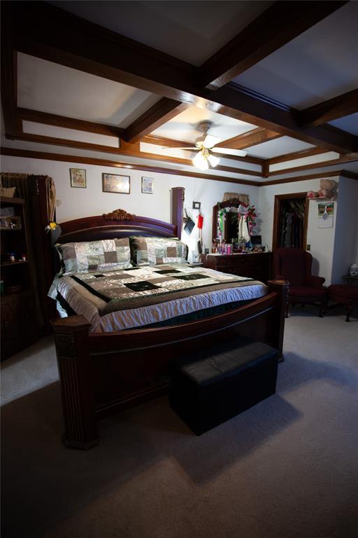 11332 Cimarron Dr, Oklahoma City, OK 73162 - carpeted bedroom featuring beamed ceiling