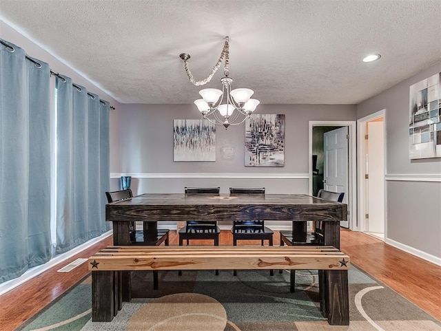 12601 Rock Springs Rd, Jones, OK 73049 - dining space with a textured ceiling, a chandelier, wood finished floors, recessed lighting, and baseboards