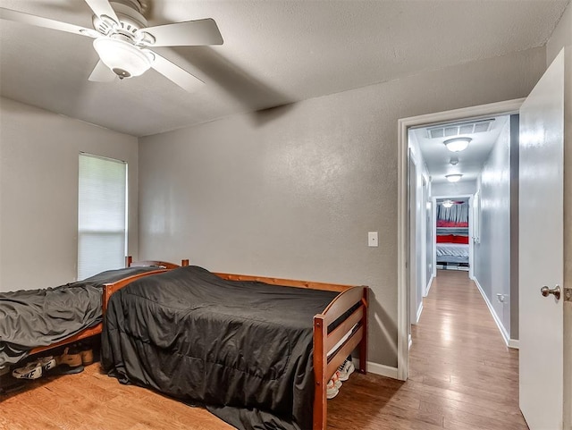 12601 Rock Springs Rd, Jones, OK 73049 - bedroom featuring wood finished floors, ceiling fan, and baseboards