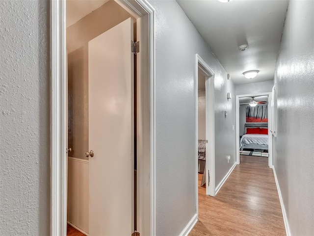 12601 Rock Springs Rd, Jones, OK 73049 - hall featuring light wood-style flooring, baseboards, and a textured wall