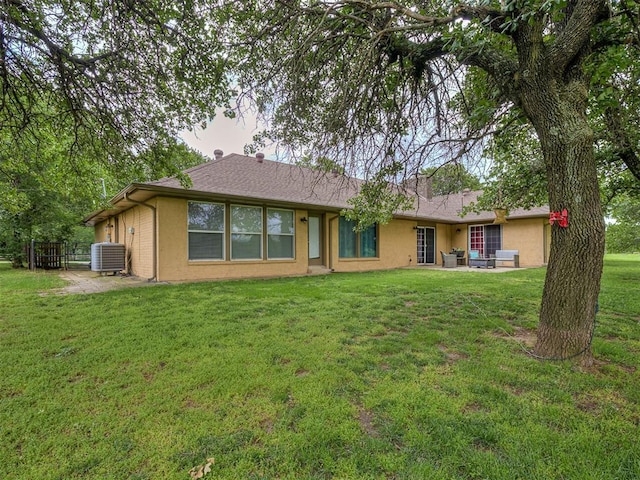 12601 Rock Springs Rd, Jones, OK 73049 - back of property with central AC, a yard, a patio area, stucco siding, and an outdoor living space
