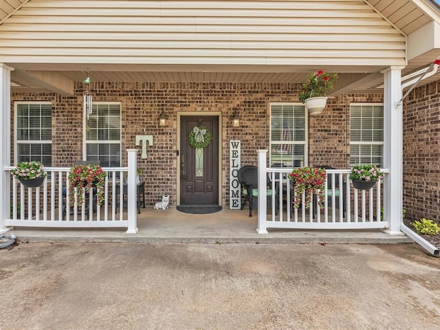20486 Cypress Way, Tecumseh, OK 74873 - view of exterior entry with a porch and brick siding