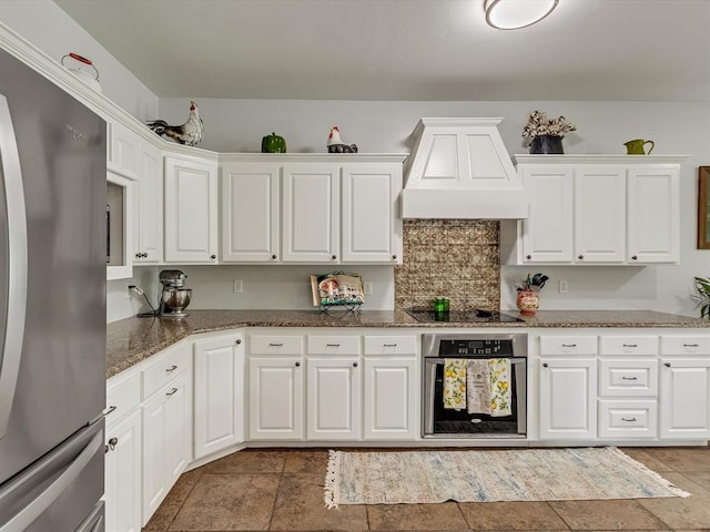 20486 Cypress Way, Tecumseh, OK 74873 - kitchen featuring appliances with stainless steel finishes, custom exhaust hood, white cabinetry, and dark stone counters