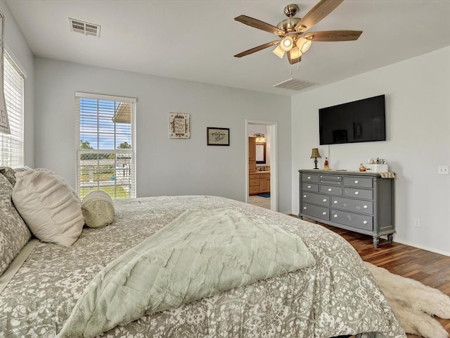 20486 Cypress Way, Tecumseh, OK 74873 - bedroom featuring wood finished floors, a ceiling fan, baseboards, and connected bathroom