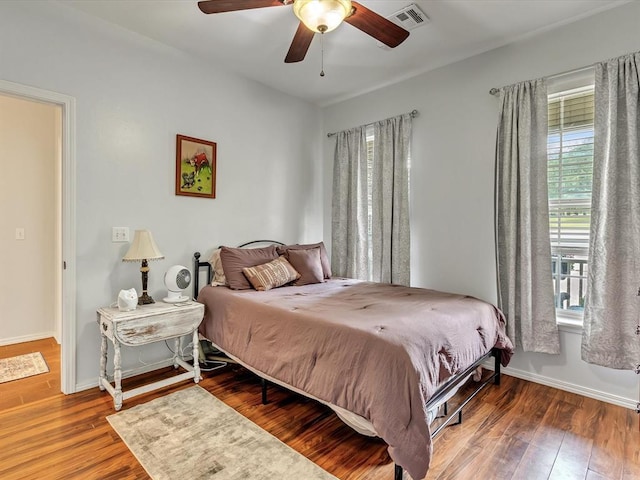 20486 Cypress Way, Tecumseh, OK 74873 - bedroom featuring wood finished floors, baseboards, and a ceiling fan