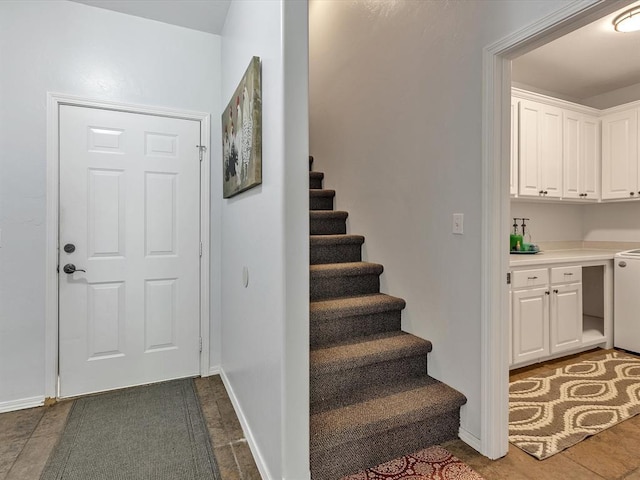 20486 Cypress Way, Tecumseh, OK 74873 - foyer entrance featuring stairs, dark tile patterned flooring, and baseboards