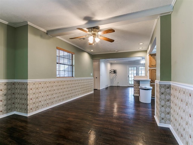 4308 NW 60th Pl, Oklahoma City, OK 73112 - spare room with wainscoting, wallpapered walls, dark wood-style flooring, a ceiling fan, and ornamental molding