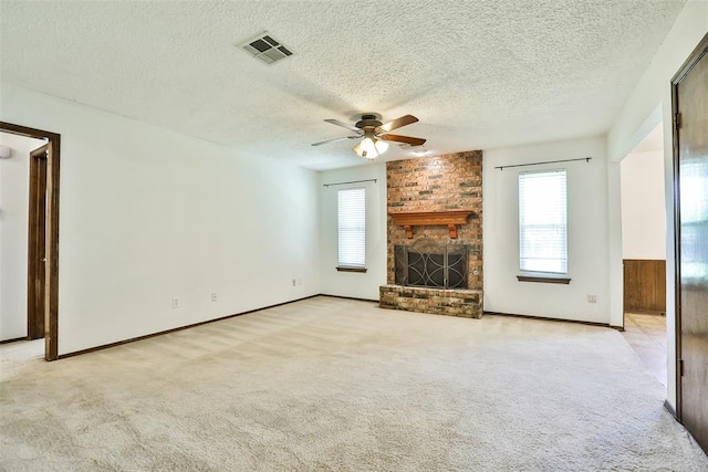 1101 S English St, Moore, OK 73160 - unfurnished living room featuring a textured ceiling, ceiling fan, light carpet, and a fireplace