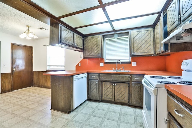 1101 S English St, Moore, OK 73160 - kitchen with white appliances, a sink, light floors, a chandelier, and a wainscoted wall