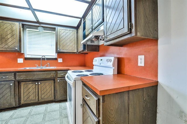 1101 S English St, Moore, OK 73160 - kitchen with electric stove, under cabinet range hood, a sink, and light floors