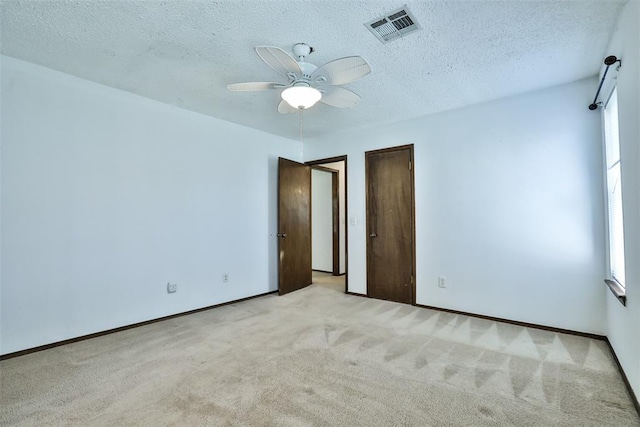 1101 S English St, Moore, OK 73160 - unfurnished room with carpet, plenty of natural light, ceiling fan, and a textured ceiling