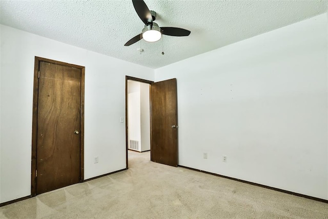 1101 S English St, Moore, OK 73160 - unfurnished bedroom with light carpet, a textured ceiling, baseboards, a ceiling fan, and a closet