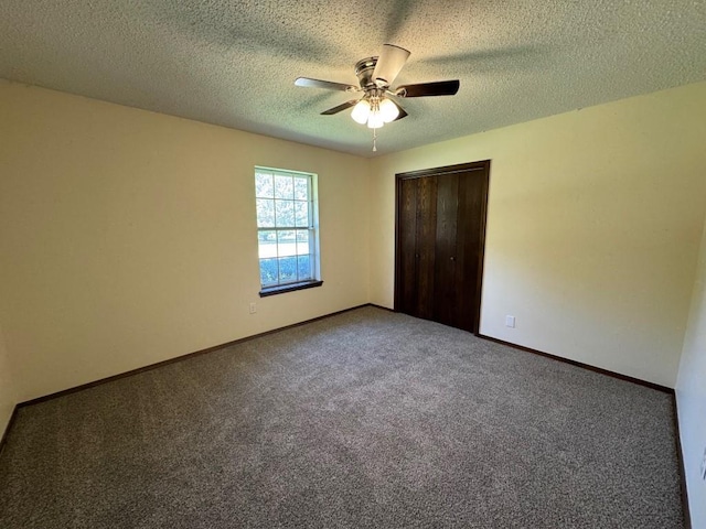 19 Mohican Cir, Shawnee, OK 74801 - unfurnished bedroom featuring carpet floors, a closet, baseboards, a textured ceiling, and a ceiling fan