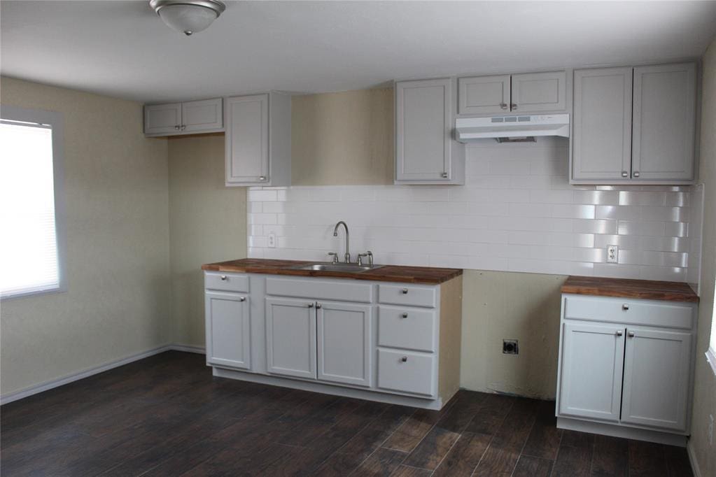 333350 Saddle Up Dr, Mcloud, OK 74851 - kitchen featuring under cabinet range hood, butcher block counters, plenty of natural light, and decorative backsplash