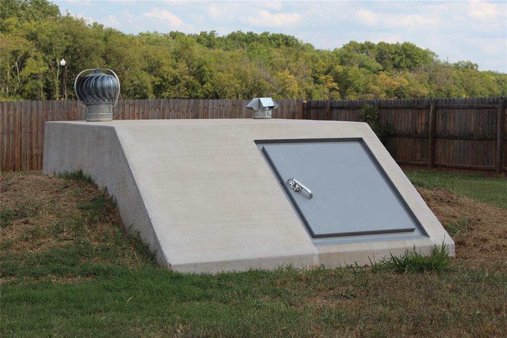 333350 Saddle Up Dr, Mcloud, OK 74851 - entry to storm shelter featuring a fenced backyard