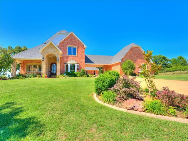 512 E Prairie Grove Rd, Guthrie, OK 73044 - traditional home with a front lawn and brick siding