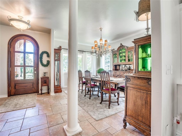 512 E Prairie Grove Rd, Guthrie, OK 73044 - foyer entrance with stone tile floors, a chandelier, ornate columns, crown molding, and baseboards