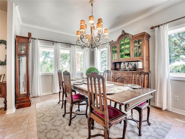 512 E Prairie Grove Rd, Guthrie, OK 73044 - dining room featuring a chandelier, ornamental molding, stone tile floors, and baseboards