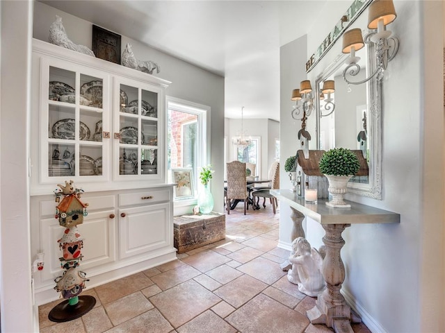 512 E Prairie Grove Rd, Guthrie, OK 73044 - foyer entrance with a chandelier, baseboards, and stone tile flooring