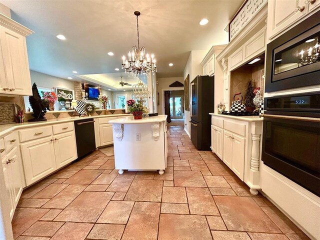512 E Prairie Grove Rd, Guthrie, OK 73044 - kitchen with black appliances, recessed lighting, stone tile flooring, a chandelier, and light countertops