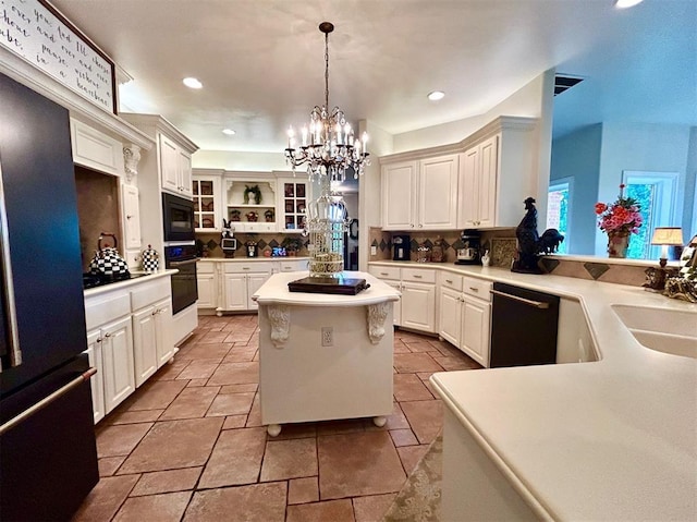 512 E Prairie Grove Rd, Guthrie, OK 73044 - kitchen with black appliances, a sink, a chandelier, a center island, and hanging light fixtures