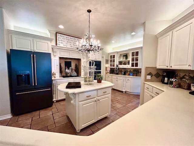 512 E Prairie Grove Rd, Guthrie, OK 73044 - kitchen with high quality fridge, stone tile floors, a kitchen island, a chandelier, and light countertops