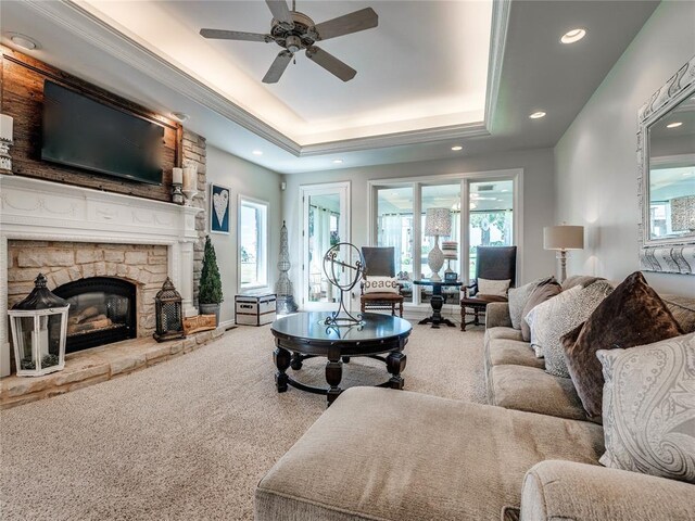 512 E Prairie Grove Rd, Guthrie, OK 73044 - carpeted living room with a raised ceiling, a ceiling fan, recessed lighting, plenty of natural light, and a fireplace