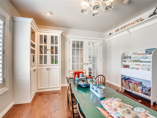 512 E Prairie Grove Rd, Guthrie, OK 73044 - dining area featuring french doors, light wood-style floors, a chandelier, and baseboards