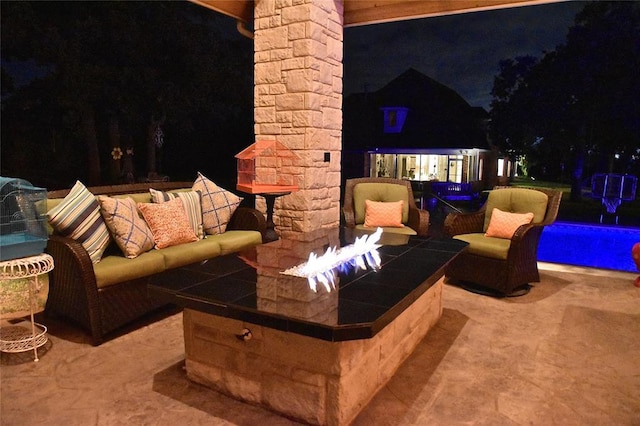 512 E Prairie Grove Rd, Guthrie, OK 73044 - patio at night featuring a patio, an outdoor pool, and an outdoor living space with a fire pit