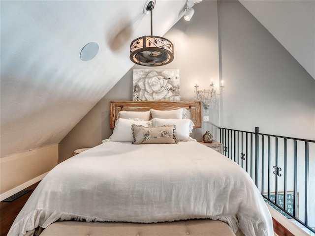 512 E Prairie Grove Rd, Guthrie, OK 73044 - bedroom featuring vaulted ceiling, wood finished floors, and baseboards
