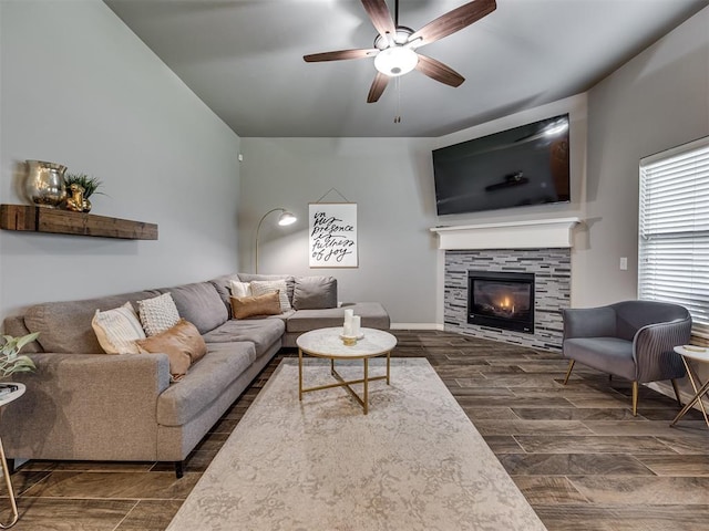 8109 NW 160th Ter, Edmond, OK 73013 - living area with ceiling fan, a tiled fireplace, and dark wood-style flooring