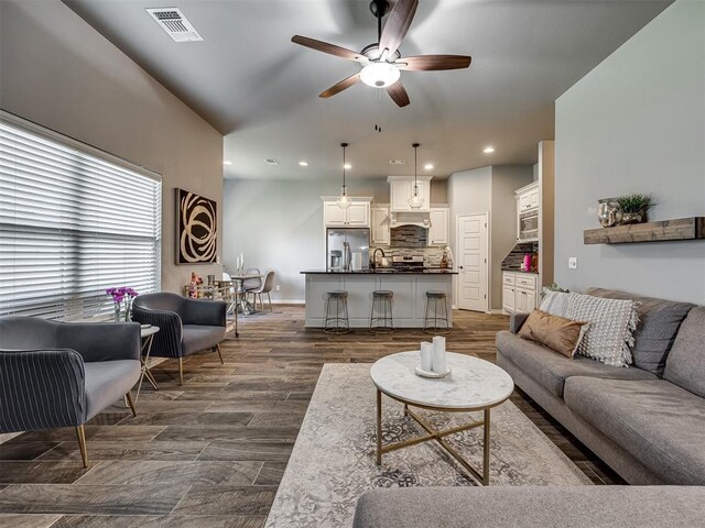 8109 NW 160th Ter, Edmond, OK 73013 - living room featuring ceiling fan, recessed lighting, dark wood-style floors, and baseboards