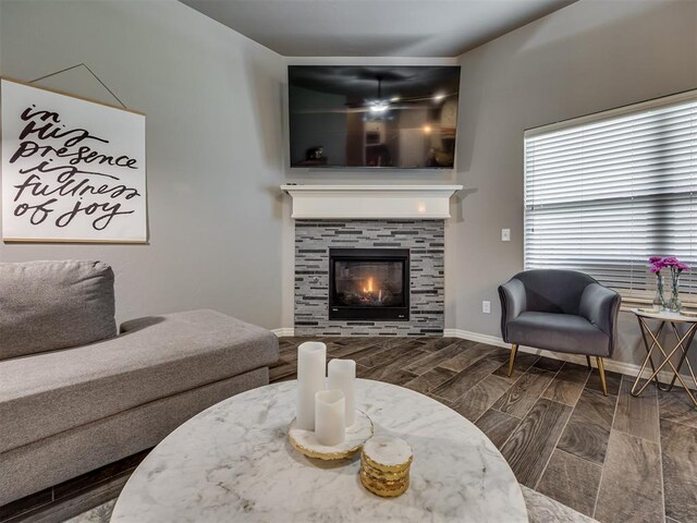 8109 NW 160th Ter, Edmond, OK 73013 - living area with a tile fireplace and baseboards