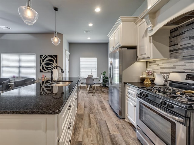8109 NW 160th Ter, Edmond, OK 73013 - kitchen featuring stainless steel appliances, a sink, light wood-type flooring, white cabinets, and backsplash
