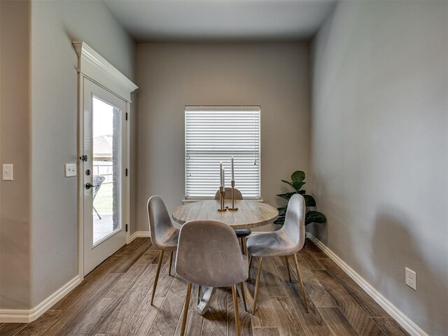 8109 NW 160th Ter, Edmond, OK 73013 - dining space featuring baseboards and wood finished floors