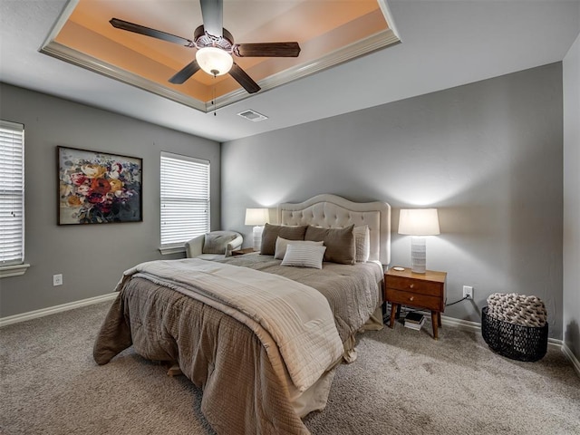 8109 NW 160th Ter, Edmond, OK 73013 - carpeted bedroom featuring a raised ceiling, baseboards, and multiple windows