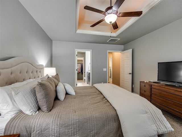 8109 NW 160th Ter, Edmond, OK 73013 - carpeted bedroom featuring a raised ceiling and a ceiling fan