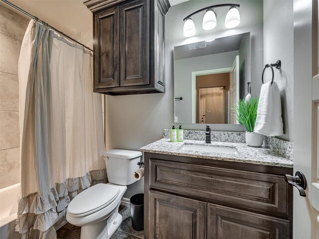 8109 NW 160th Ter, Edmond, OK 73013 - full bathroom with vanity, toilet, and shower / bath combo with shower curtain