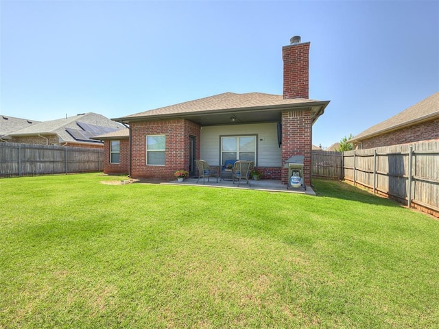 8109 NW 160th Ter, Edmond, OK 73013 - rear view of house with a patio area, a chimney, and brick siding