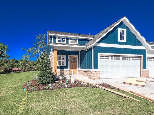 701 Montauk Way, Edmond, OK 73034 - view of front of home with a front yard, board and batten siding, concrete driveway, and brick siding