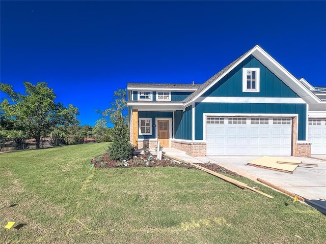 701 Montauk Way, Edmond, OK 73034 - view of front of home with board and batten siding, concrete driveway, brick siding, and a garage