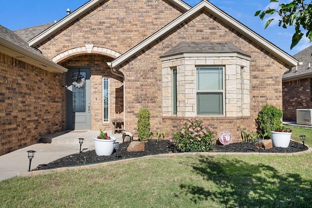 3409 Ontario Cir, Oklahoma City, OK 73160 - view of exterior entry with a yard and brick siding