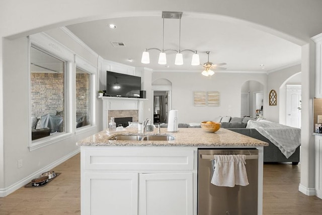 3409 Ontario Cir, Oklahoma City, OK 73160 - kitchen featuring open floor plan, a sink, a ceiling fan, dishwasher, and a fireplace