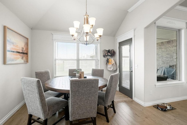 3409 Ontario Cir, Oklahoma City, OK 73160 - dining area with a chandelier, lofted ceiling, plenty of natural light, baseboards, and wood finished floors