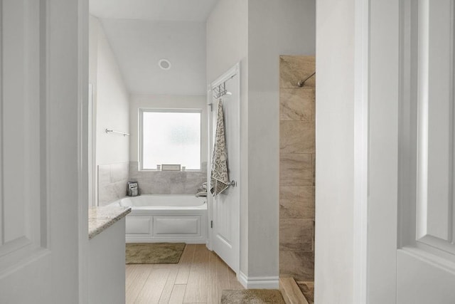 3409 Ontario Cir, Oklahoma City, OK 73160 - bathroom with tiled shower, a garden tub, and wood finished floors
