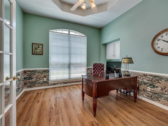 8413 NW 64th Ter, Oklahoma City, OK 73132 - office area featuring light wood-type flooring, a wainscoted wall, a ceiling fan, wallpapered walls, and baseboards