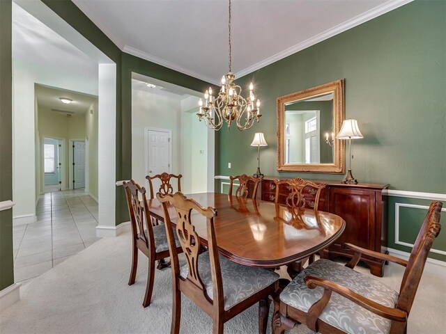 8413 NW 64th Ter, Oklahoma City, OK 73132 - dining area featuring ornamental molding, a chandelier, light colored carpet, light tile patterned flooring, and a wainscoted wall